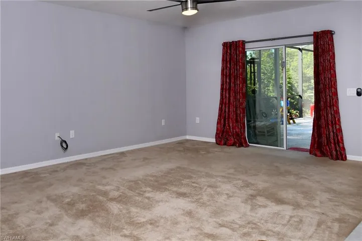 Spare room with light carpet and ceiling fan