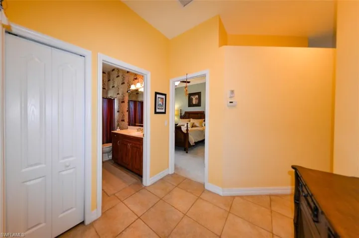 Hallway with light tile patterned flooring