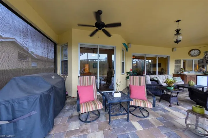 View of patio with outdoor lounge area and ceiling fan