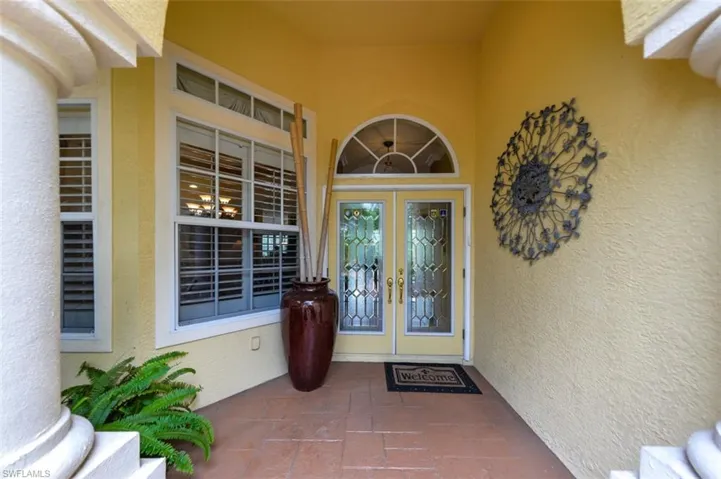 Doorway to property featuring covered porch