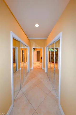 Corridor featuring light tile patterned floors