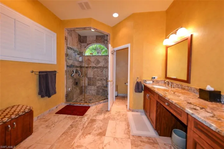 Bathroom with vanity, an enclosed shower, and tile patterned floors