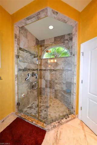 Bathroom featuring walk in shower and tile patterned flooring