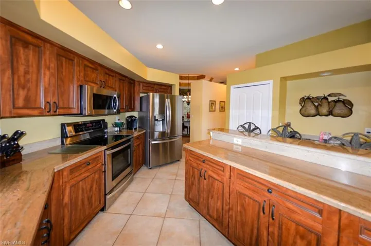 Kitchen featuring appliances with stainless steel finishes and light tile patterned floors