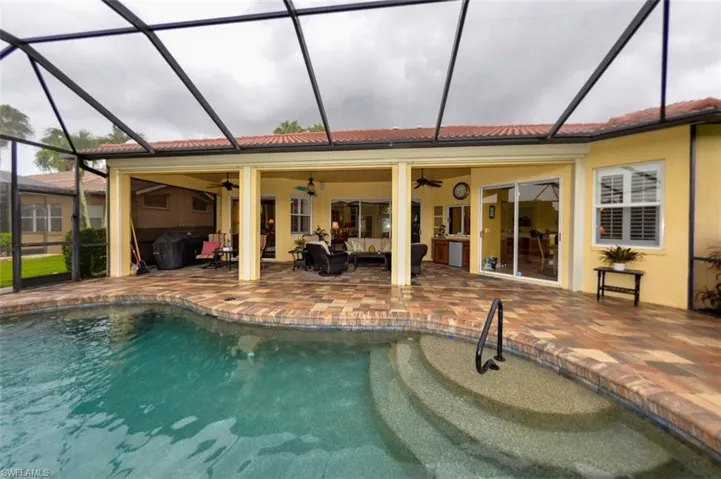 View of swimming pool with a patio area, ceiling fan, an outdoor hangout area, a lanai, and area for grilling