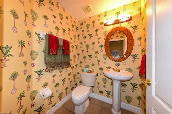 Bathroom with toilet and tile patterned floors