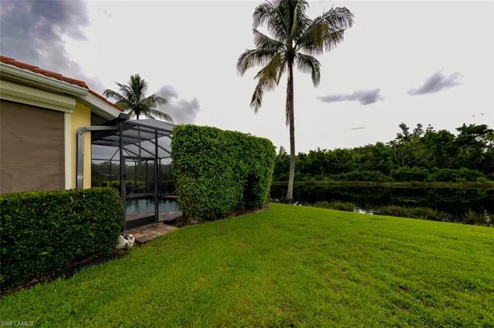 View of yard with a water view and a lanai