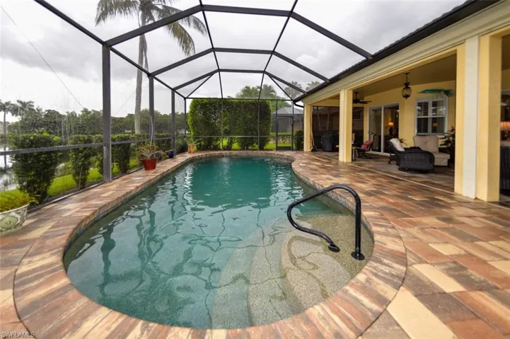 View of swimming pool with a lanai, a patio area, and ceiling fan