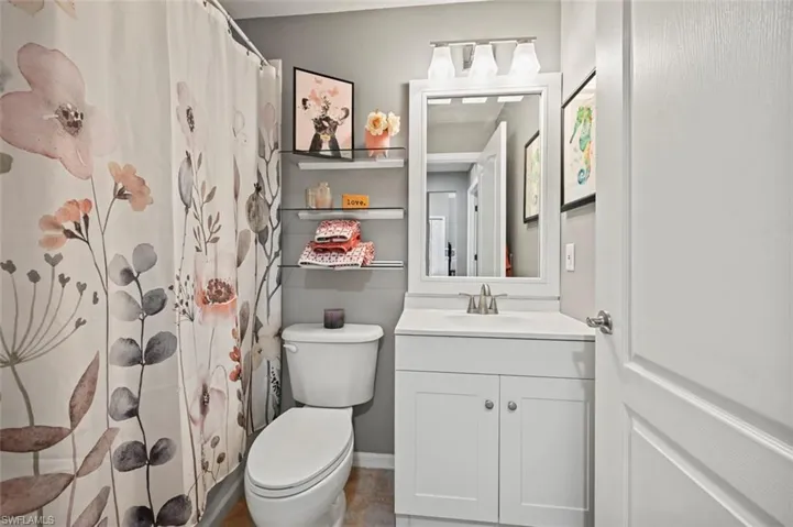 Bathroom with vanity, toilet, and tile patterned floors