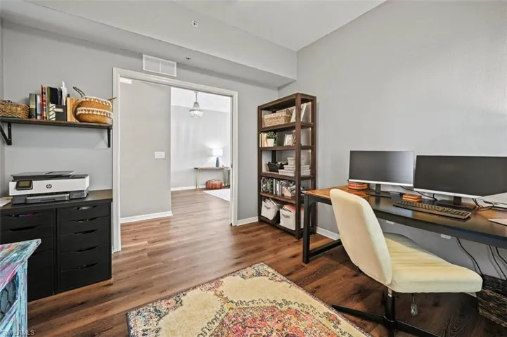 Office space featuring dark wood-type flooring