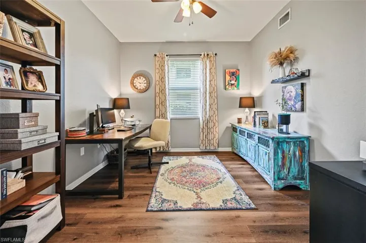 Office area featuring dark hardwood / wood-style floors and ceiling fan