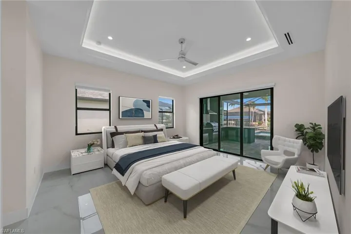 Bedroom featuring marble finish floor, recessed lighting, a raised ceiling, and access to exterior