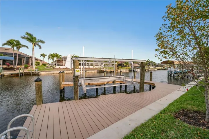View of dock with a water view and boat lift