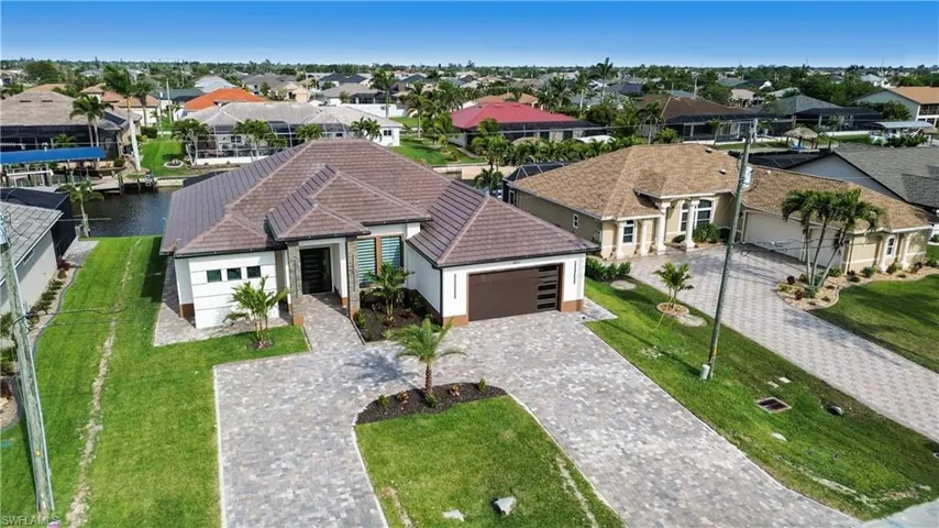Birds eye view of property featuring a water view and a residential view