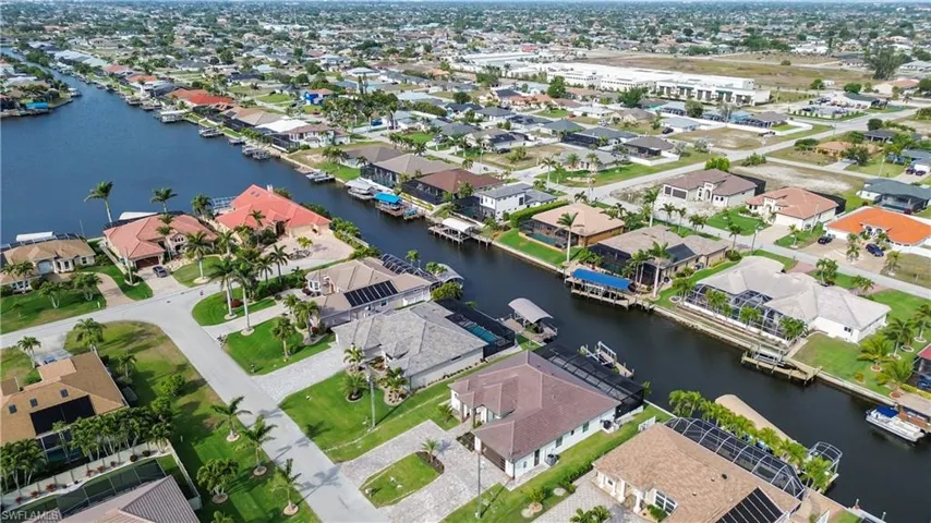 Aerial view featuring a water view and a residential view