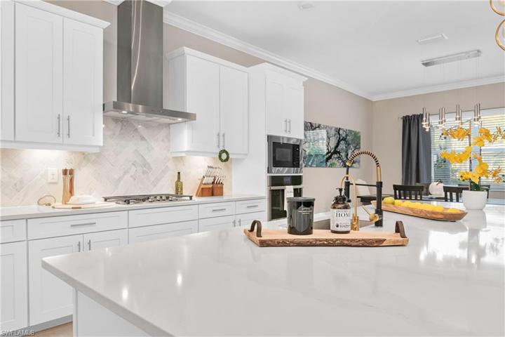 Custom Backsplash and quartz counters in kitchen.