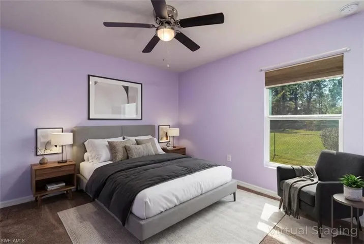Carpeted bedroom featuring baseboards and a ceiling fan (Digitally Staged)