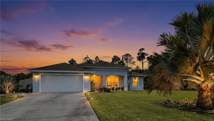 View of front of house with stucco siding, a garage, a front lawn, and concrete driveway (Digital Sunset)
