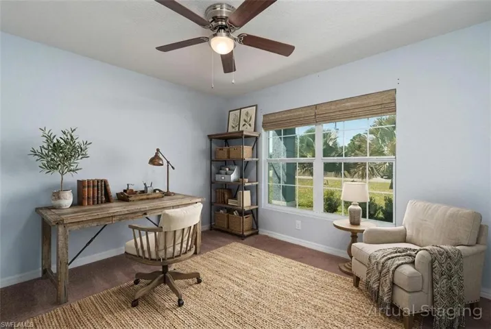 Home office featuring ceiling fan and carpet floors (Digitally Staged)