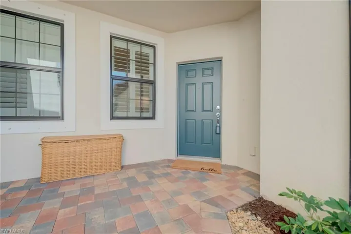 Entrance to property with stucco siding