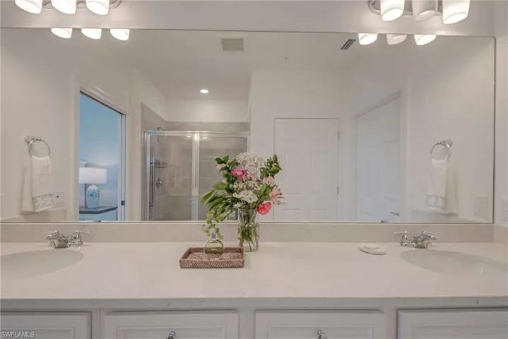 Master Bathroom featuring double vanity and a walk-in shower