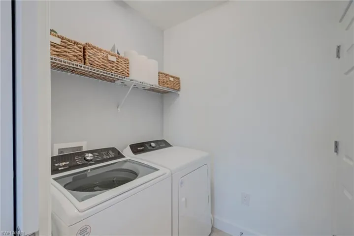 Laundry area w/pocket slider featuring separate washer and dryer