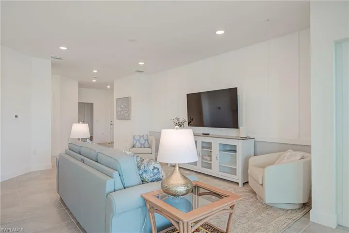 Family area with recessed lighting , Convenient Floor outlet, & decorative wood accent wall