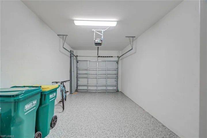 1 C Garage featuring Epoxy flooring, concrete block wall & garage door opener
