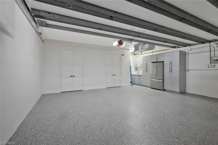 Private secure garage with expoxy flooring and freestanding storage.