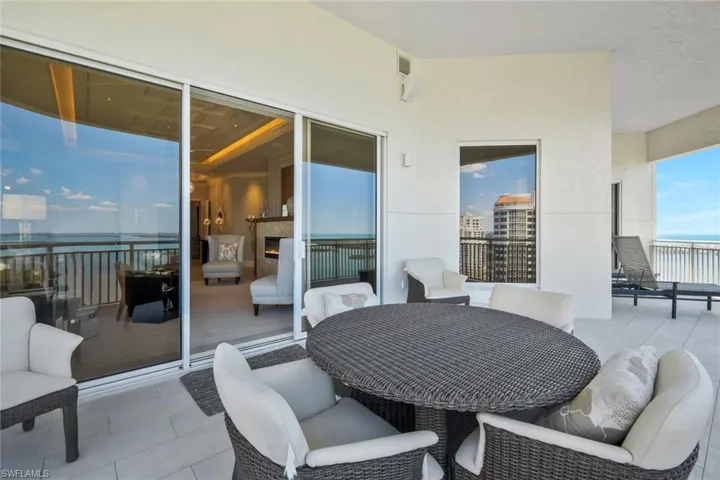 The balcony wraps around the living room and primary suite.