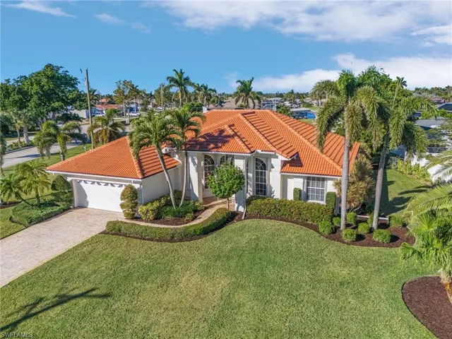 Mediterranean / spanish house with a front lawn and a garage
