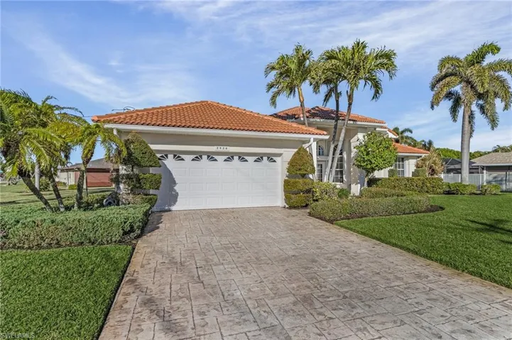 Mediterranean / spanish-style home with a front yard and a garage