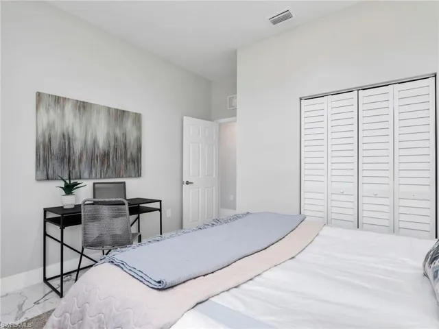 Bedroom featuring light gray walls and white trim