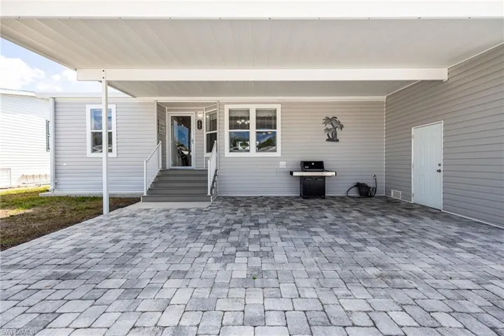 Property entrance with a patio and a carport