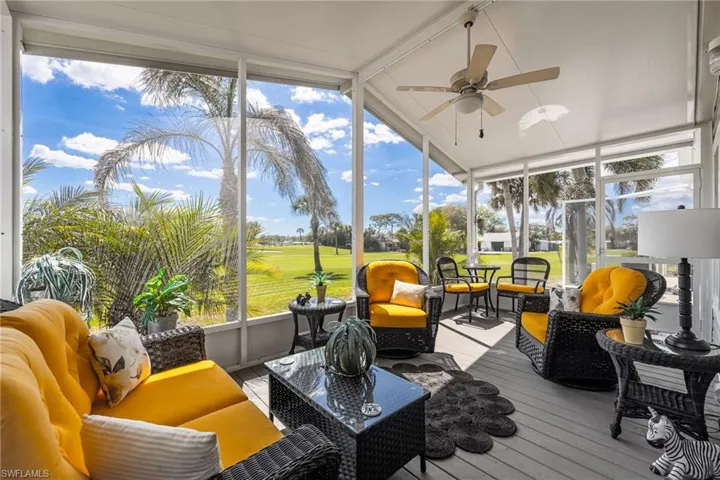 Sunroom / solarium with outdoor lounge area, ceiling fan, and view of golf course