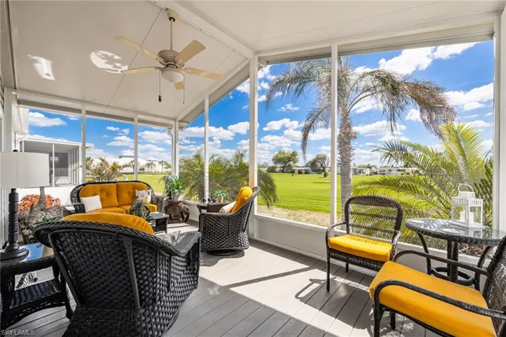 Sunroom featuring a ceiling fan, an outdoor hangout area, view of golf course, and lofted ceiling