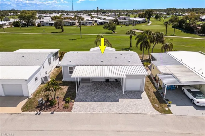 Aerial perspective of suburban area featuring a local golf course
