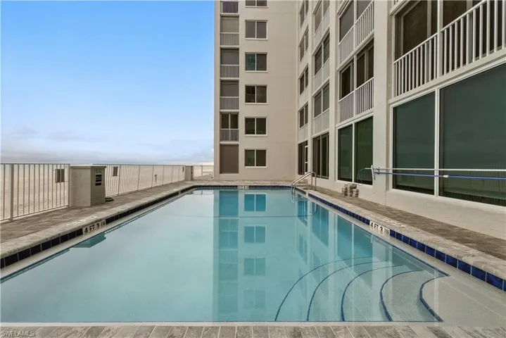Community pool with a patio