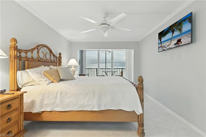 Bedroom featuring ornamental molding, access to outside, a ceiling fan, and tile patterned flooring