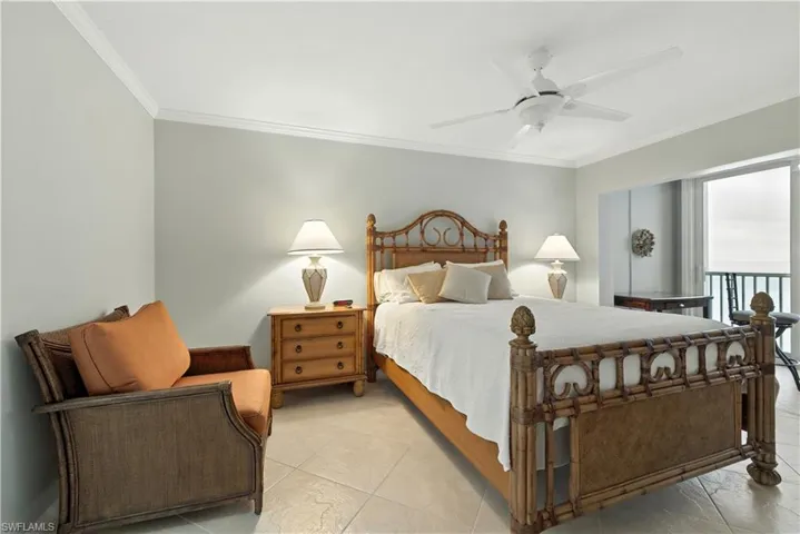 Tiled bedroom featuring ornamental molding, a ceiling fan, and access to outside