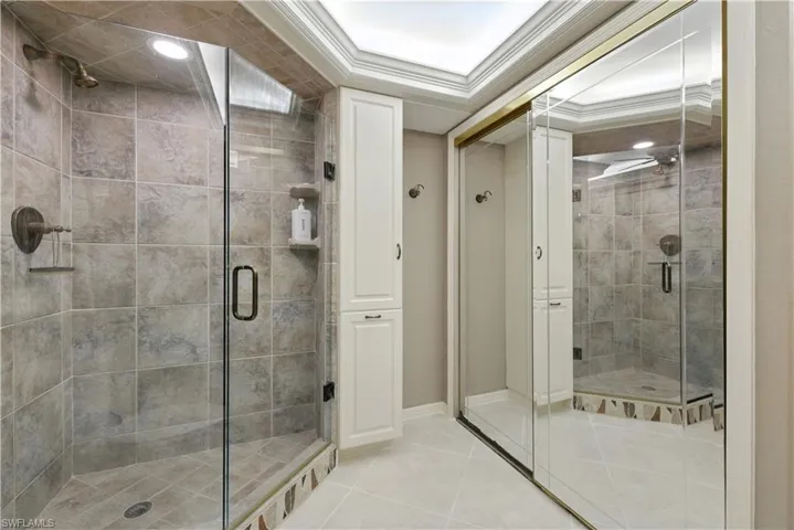 Full bathroom with tile patterned flooring, crown molding, a shower stall, and recessed lighting
