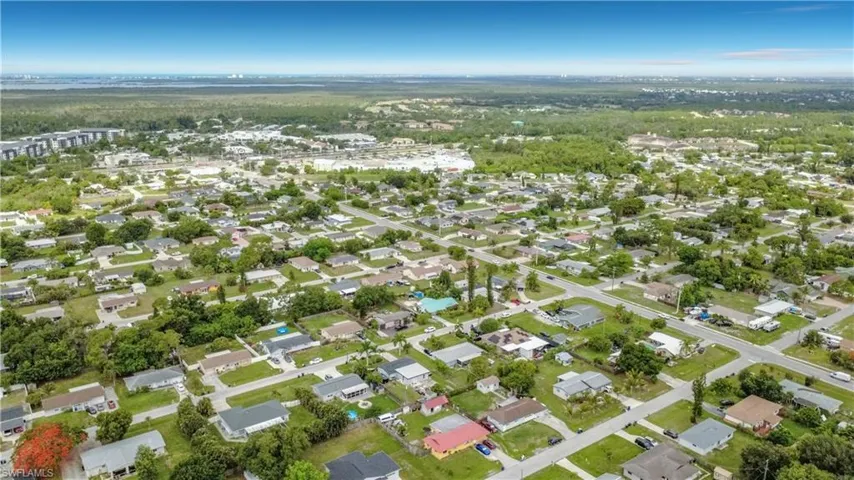 Residential neighborhood with street grid, mature trees, and varying rooflines