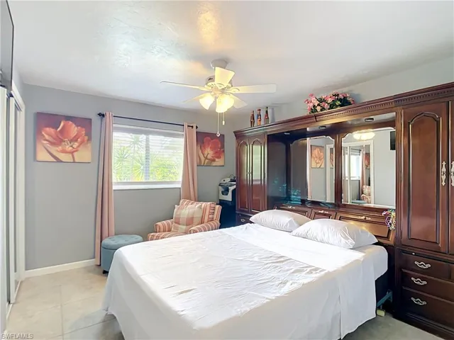 Spacious room featuring tile flooring and a ceiling fan with integrated lighting