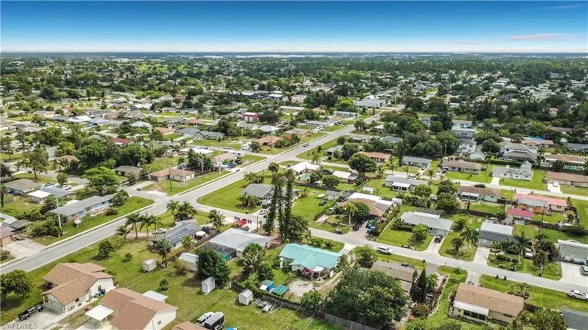 Aerial perspective showcasing a residential neighborhood with a clear sky backdrop