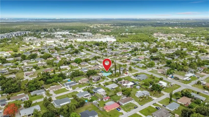 Aerial perspective showcasing a residential neighborhood with a mix of established homes and mature trees