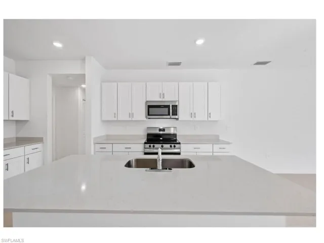 Large center island with breakfast bar seating.