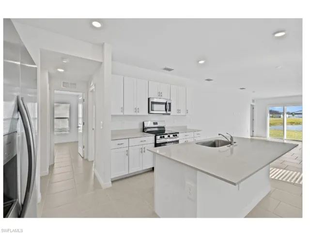 Open-concept kitchen overlooking the main living area.