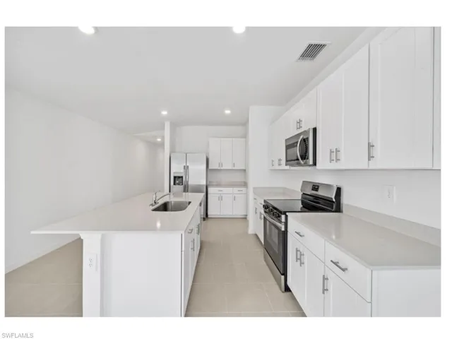 Modern kitchen with ample cabinetry and counter space.