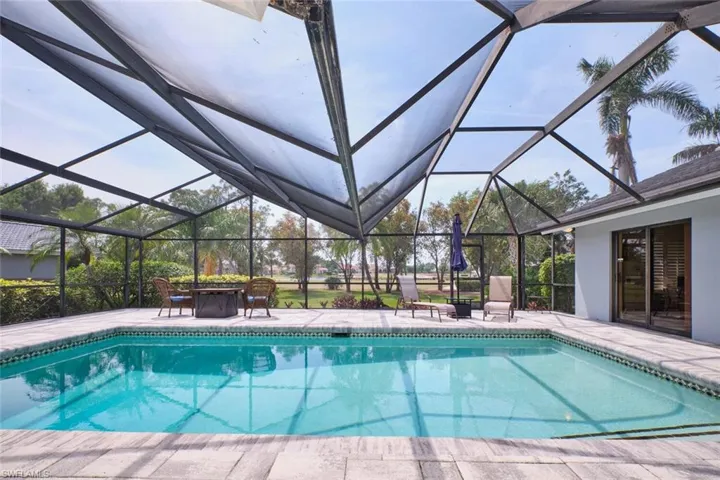 Inviting pool with screen enclosure and a paver patio area.