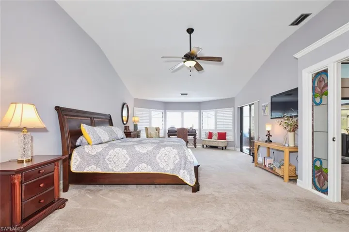 Owner's suite has plenty of room for a sitting area, and sliders out to the screened lanai.